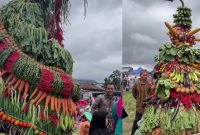 A festive tower of fresh vegetables and fruits at the harvest celebration.