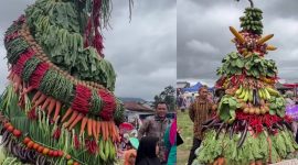 A festive tower of fresh vegetables and fruits at the harvest celebration.