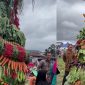 A festive tower of fresh vegetables and fruits at the harvest celebration.