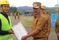 Bupati Kerinci Monadi menyerahkan sertifikat kompetensi kepada tenaga kerja konstruksi di halaman Kantor Bupati, Senin (1/9/2025).