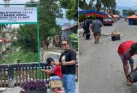 Lurah Sungai Penuh, Wiwin Septiadi, saat memasang papan larangan membuang sampah di kawasan Sungai Bungkal.