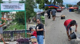 Lurah Sungai Penuh, Wiwin Septiadi, saat memasang papan larangan membuang sampah di kawasan Sungai Bungkal.