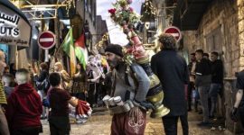 Seorang pria menjual kopi di Lapangan Kelahiran Yesus saat penyalaan pohon Natal di Betlehem, 6 Desember 2025.