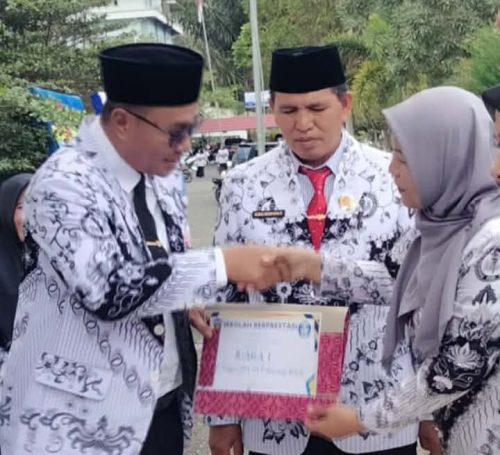 Kepala SD 004/XI Pelayang Raya, Lenza Hasmita, M.Pd, menerima penghargaan Juara 1 Sekolah Berprestasi dari Wali Kota Sungai Penuh, Alfin, SH, di halaman Kantor Walikota Sungai Penuh.