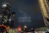 Atraksi drone membentuk tulisan “Jakarta for Sumatra” menghiasi langit Bundaran HI saat perayaan malam Tahun Baru di Jakarta.