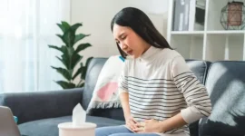 Ilustrasi seseorang memegang perut karena terasa begah setelah berbuka puasa.