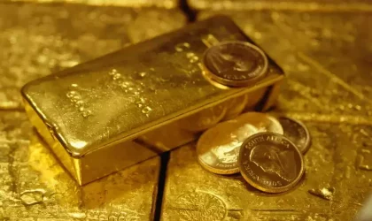 Ilustrasi batangan emas dengan kilau reflektif sebagai simbol investasi