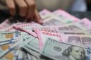 Ilustrasi rupiah dan dolar AS yang mencerminkan tekanan nilai tukar terhadap perekonomian dan industri nasional.(Fhoto : Bloomberg Technoz/ Andrean Kristianto)