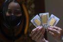 Foto: Karyawati menunjukkan emas PT Aneka Tambang Tbk. (Antam) di salah satu gallery penjualan emas di Jakarta, Kamis (4/5). (CNBC Indonesia/Muhammad Sabki)