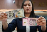 Ilustrasi pergerakan nilai tukar rupiah terhadap dolar AS ( Foto Tribune wa.com)