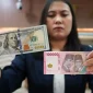 Ilustrasi pergerakan nilai tukar rupiah terhadap dolar AS ( Foto Tribune wa.com)