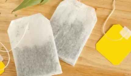 Kantong teh celup dalam cangkir yang diseduh air panas sebagai ilustrasi potensi paparan mikroplastik dari teh kemasan.