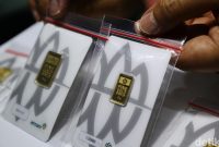 Petugas menunjukkan emas batangan Antam di butik Logam Mulia, seiring penurunan harga emas hari ini ke Rp 2.615.000 per gram.( Foto: Ari Saputra )