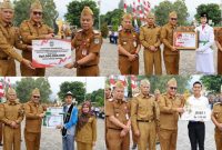 Wali Kota Sungai Penuh Alfin, S.H., menyerahkan penghargaan kepada penerima prestasi di halaman Kantor Wali Kota Sungai Penuh, Senin (31/8/2026).