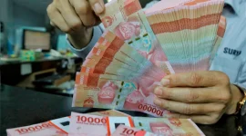 Rupiah melemah ke Rp18.035 per dolar AS seiring tekanan pasar global dan kenaikan harga minyak.(Foto : Liputan6.com/Angga Yuniar)