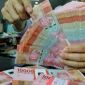 Rupiah melemah ke Rp18.035 per dolar AS seiring tekanan pasar global dan kenaikan harga minyak.(Foto : Liputan6.com/Angga Yuniar)