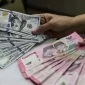 Ilustrasi penukaran mata uang dolar AS dan rupiah. (Foto: achmadnurhidayat.id)